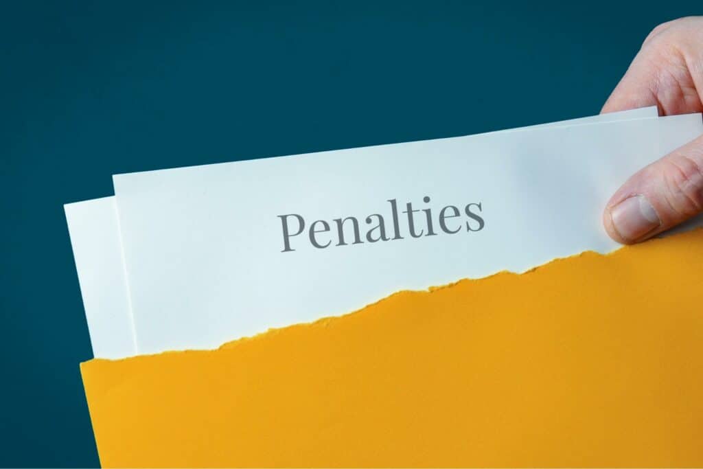 Papers people pulled out of a torn envelope with the word Penalties on it.