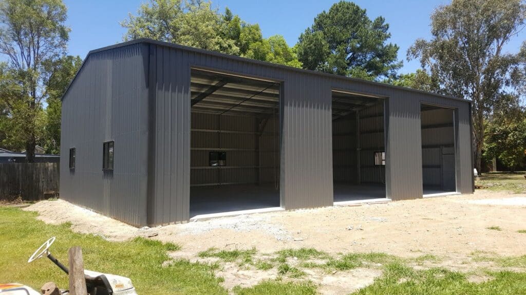 A metal shed with 3 open bays.
