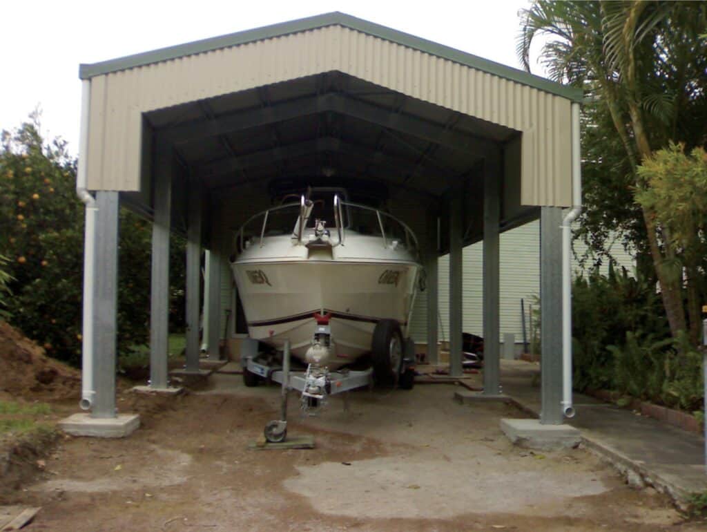 Metal shed with open sides housing a boat.